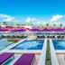 Planet Hollywood Adult Scene Cancun, An Autograph Collection Resort - Adults Only pool deck with purple loungers and ocean view in Cancún