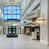 Embassy Suites by Hilton Raleigh Durham Airport Brier Creek lobby with vaulted ceiling, chandeliers and central fountain sculpture in Raleigh
