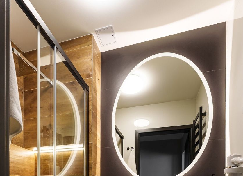Hotel New Skanpol, Kolobrzeg bathroom with glass shower, toilet and oval backlit mirror
