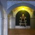 Casa Armonia in San Miguel de Allende: arched brick hallway with ladder shelf and potted plants