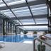 Vip Hotel in Doha indoor pool with lounge chairs and skylit glass roof