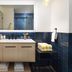 Bathroom at Inn at Cape Kiwanda in Pacific City with double vanity, mirror, and navy tile accents