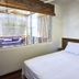 Otro Lado Lodge And Restaurant in Santa Teresa: simple bedroom with queen bed and window view
