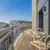 Yuna Porte-Maillot - Aparthotel in Paris: curved balcony with city skyline views and outdoor seating
