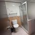 Sipadan Inn 1, Semporna: compact bathroom with toilet, shower enclosure, and sink vanity