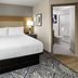 Candlewood Suites Williamsport guest room with king bed and en suite bathroom doorway