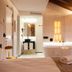 Hotel Plaza Obradoiro by Bossh! Hotels room with soaking tub, wood ceiling, and large windows in Santiago de Compostela