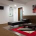 Hotel Portas De Santa Rita in Ermesinde lobby lounge with leather bench, low table and abstract wall art