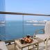 Mövenpick Hotel Jumeirah Beach balcony with chair, coffee and pastries overlooking Dubai sea and skyline