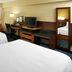 Fairfield Inn & Suites Parsippany guest room with two beds, desk, TV, and mirror