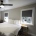 Piety Hill Cottages in Nevada City bedroom with queen bed, ceiling fan, windows and bedside lamp