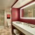 Embassy Suites by Hilton Phoenix Downtown North bathroom with large vanity, mirror, toilet and glass walk-in shower