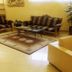 Hotel Orizzonte in Letojanni lobby with patterned sofas, glass coffee table, rug and potted plant