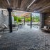 Covered outdoor patio at Courtyard by Marriott Toledo West in Toledo with lounge seating and dining tables