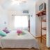 Hotel Laguna del Cocodrilo room in Tamarindo with bed, ceiling fan, window and shelving unit