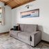Agriturismo Terra dei Limoni in Noto: bright room with sofa, window, tiled floor and wooden ceiling
