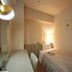 Central Hotel Fukuoka single room with bed, desk, lamp, and wall-mounted TV in Fukuoka.