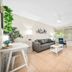 Riverwatch Apartments By Lowkl in Jensen Beach, living room with sofa, coffee table and large window view
