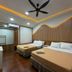 Anjung Pantai Seberang hotel room in Kuala Terengganu with two double beds and wood-accented decor