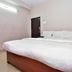 Laven Hotels, Rājahmundry guest room with a king bed and simple beige walls