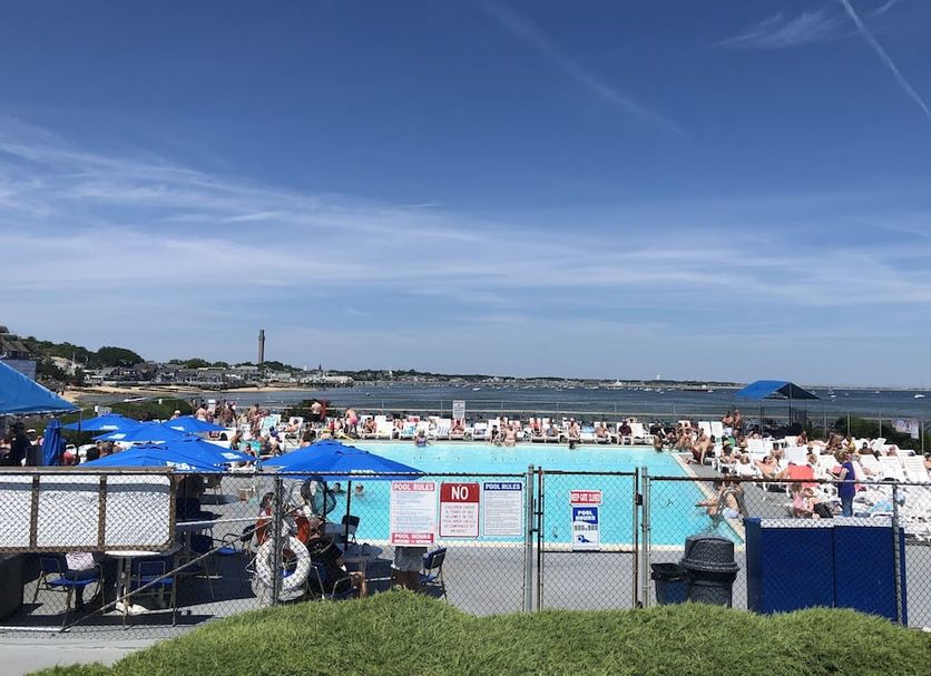 Provincetown Inn in Provincetown with outdoor pool, lounge chairs, and oceanfront beach view