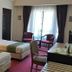 Hotel Seri Malaysia Genting Highlands room with two twin beds, chairs by the window, and a desk