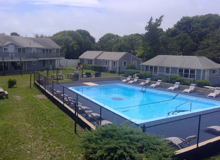 Village Green Motel in South Yarmouth with outdoor pool and lounge chairs