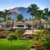 The Westin Princeville Ocean Resort Villas in Princeville with palm trees, lush lawn and mountain backdrop