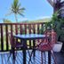 Hotel Les Bougainvilliers in Saint-Paul: balcony with table, chairs, and tropical palm view