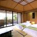 Shuzenji Onsen Katsuragawa guest room in Izu with twin beds and sliding glass doors to a patio