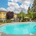 Best Western Porterville Inn pool area with outdoor swimming pool, lounge chairs, and palm trees in Porterville
