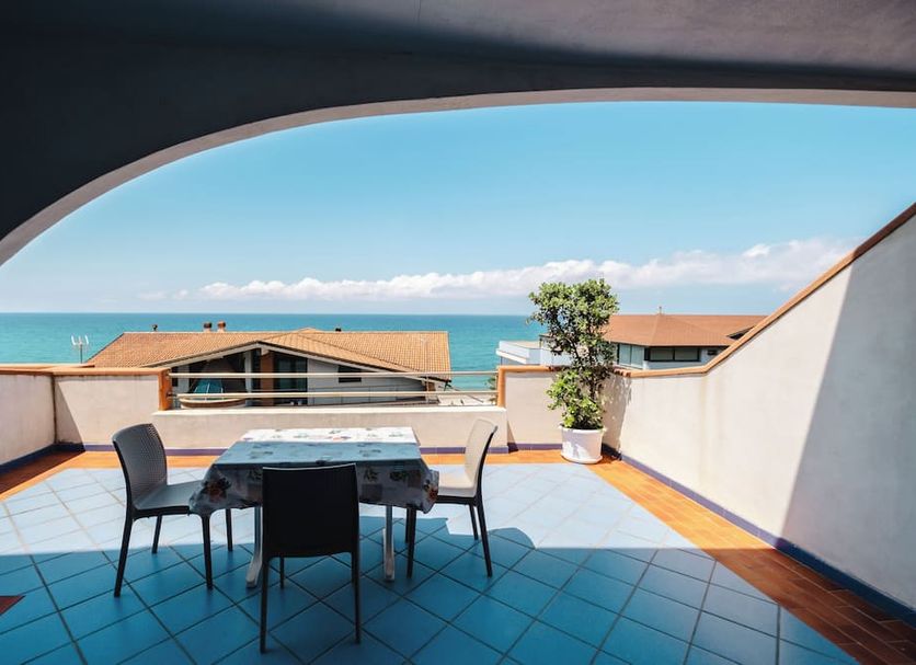 Oasi Azzurra terrace with table, chairs and sea view in Villafranca Tirrena