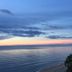 Hua Plee Lazy Beach Hotel in Hua Hin overlooking a calm beach at sunset