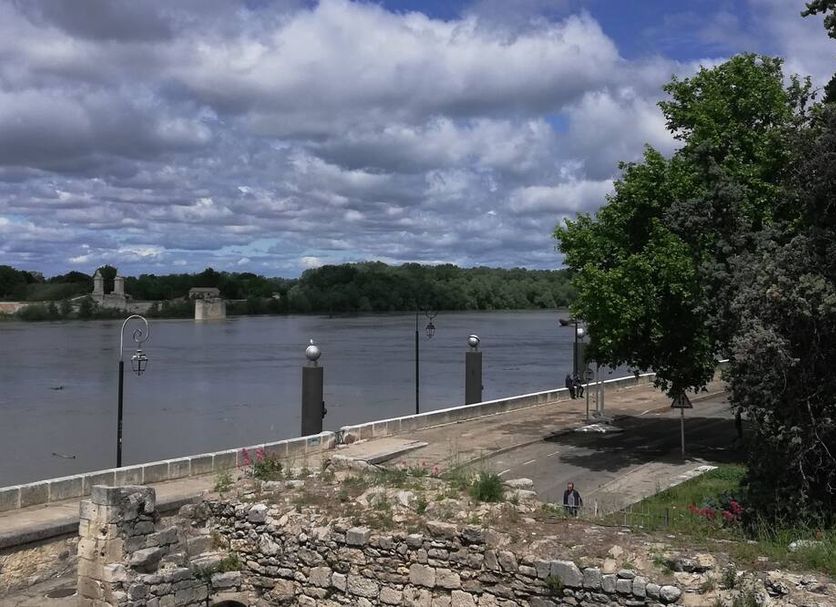 Le Régence in Arles with riverside terrace and view of the river and cloudy sky