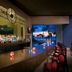 Hard Rock Hotel Vallarta bar with illuminated counter and ocean-view resort backdrop in Nuevo Vallarta