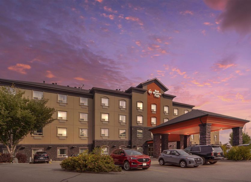 Best Western Plus St. Albert exterior at dusk with parked cars and a colorful sunset sky in Saint Albert