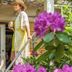 The Stella Rose B&B in Wolfville, woman in sunhat standing on porch steps amid garden flowers