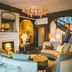 The Coed-Y-Mwstwr Hotel in Bridgend lounge with fireplace, curved sofas, chandelier and staircase