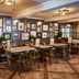 The Bluebird Inn at Samlesbury in Blackburn dining room with leather booths, tables, and framed wall art