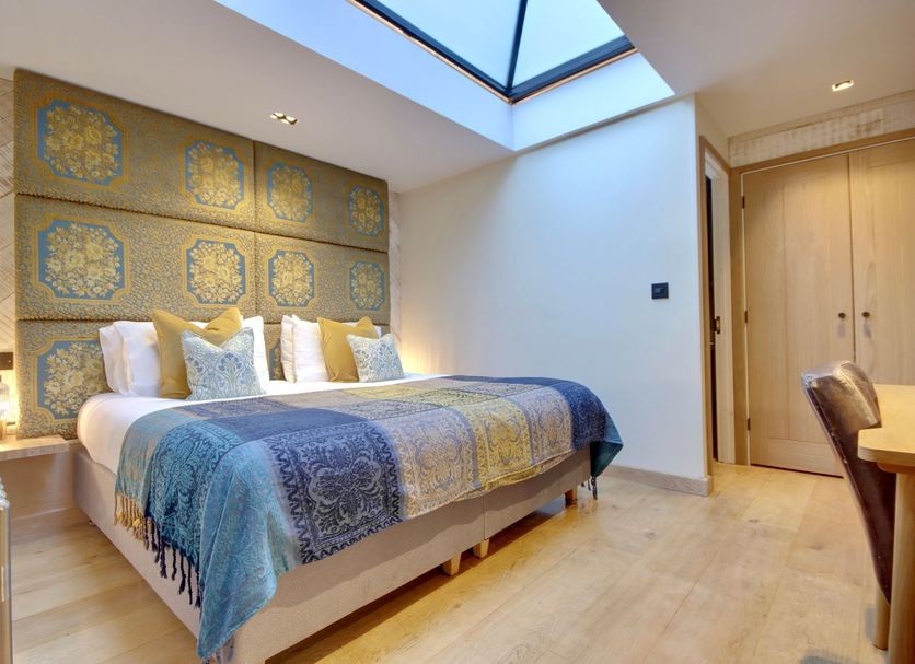Becketts Townhouse in Southsea bedroom with skylight, patterned headboard wall, and king bed