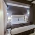 SM Hotel Teatre Auditori Barcelona guest room with canopy bed, bedside lamps and marble floor