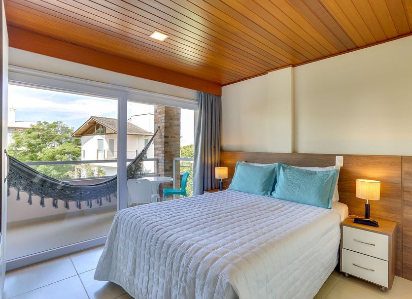 Pousada Ilha Faceira room in Florianopolis with balcony hammock and outdoor neighborhood view