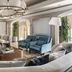 The Ritz-Carlton Orlando Grande Lakes lounge with curved sofas, blue chairs, and large chandelier