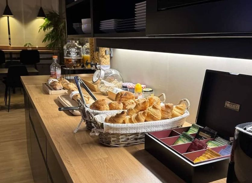 Hôtel L'Europe in Cholet breakfast buffet with pastries, bread, and tea station