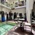 Riad Jardin Des Rêves in Marrakech courtyard pool with tables, potted trees, and upstairs balcony