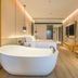 Puruihotel Yongkang in Jinhua: modern hotel room with freestanding bathtub, king bed and vanity