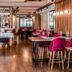 Hotel Bécquer Seville restaurant with wooden tables, velvet chairs, and warm modern decor