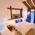 Pousada O Cantinho da Raposa in Monte Verde with a cozy bedroom, fireplace, balcony door and rustic ceiling