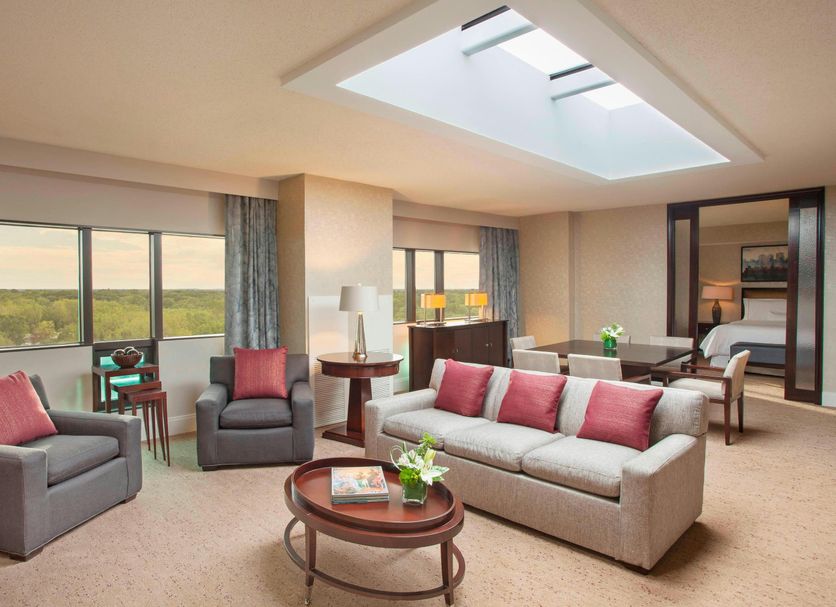 The Westin Southfield Detroit suite with skylight, seating area, and city views in Southfield