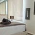 Mar Del Norte in San Juan: bright hotel room with neatly made bed and towels by a window